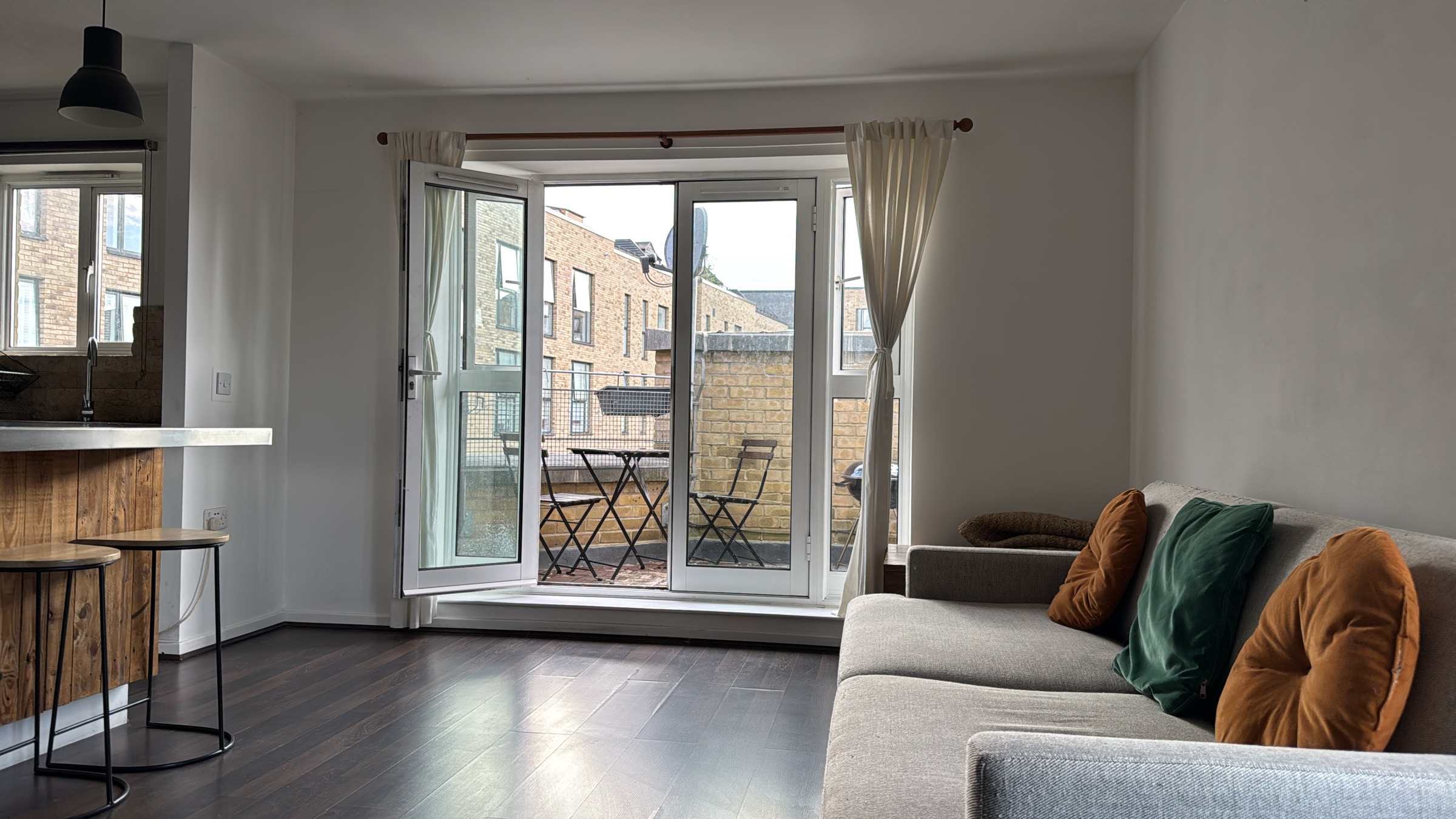 Open-plan living room opening onto the private balcony