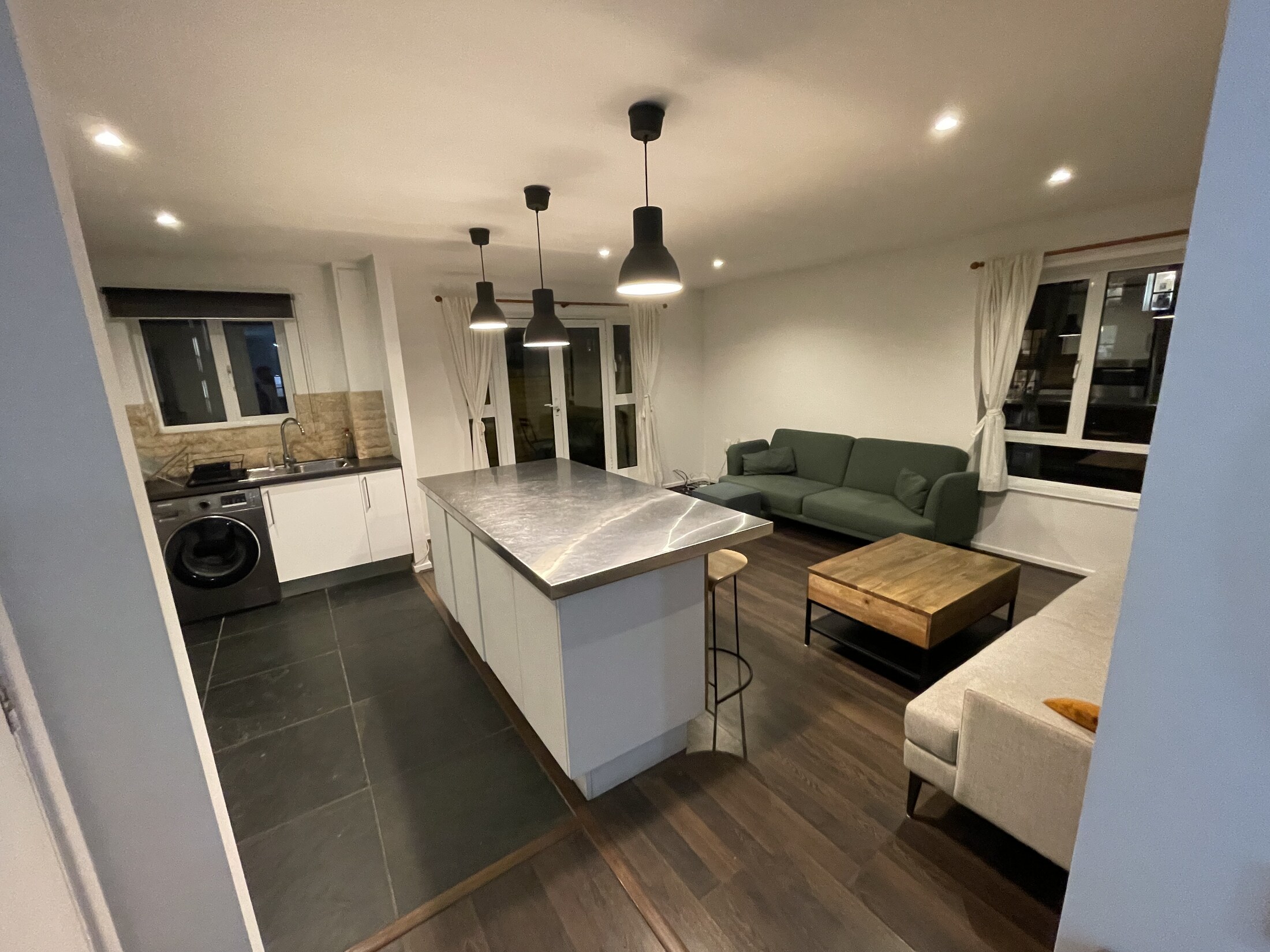 Wide view across the open-plan living room and kitchen