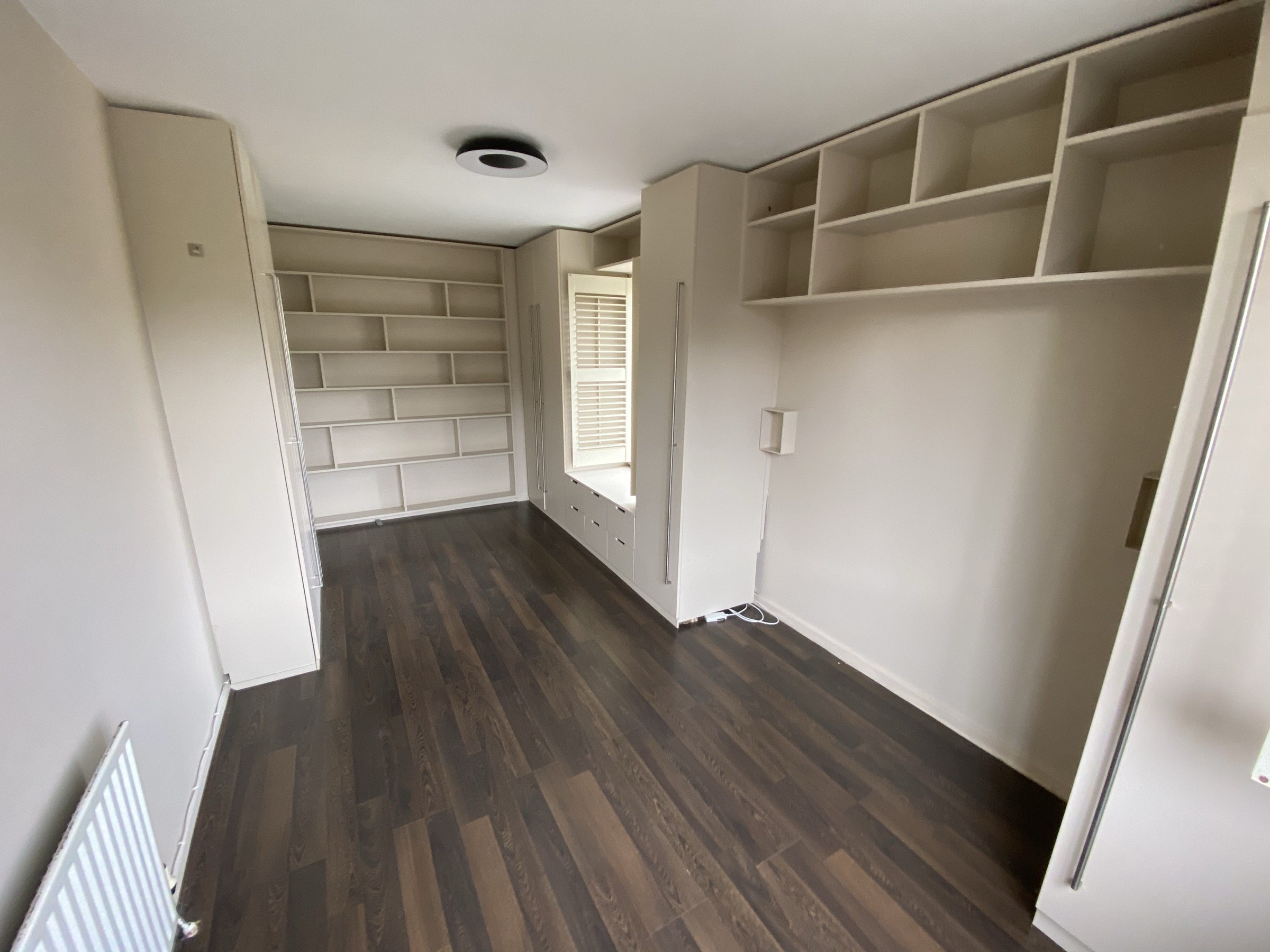 Principal bedroom with built-in shelving and storage